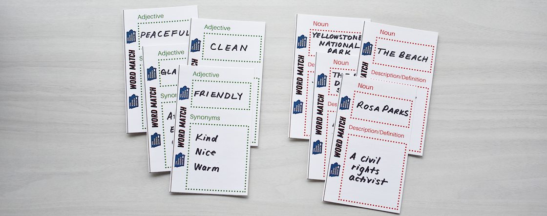 Card used for Word Match game. They have words written on white slips of paper separated in two piles. The adjective pile has words "peaceful, clean, friendly, kind, nice, warm. The noun pile has words "Yellowstone National Park, the beach, Rosa Parks, a civil rights activist".