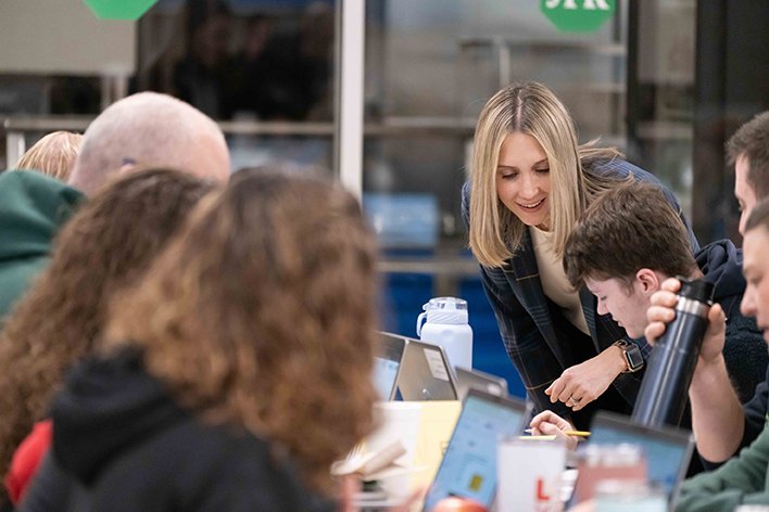 IRRC staff member talks with a teacher sitting at a table