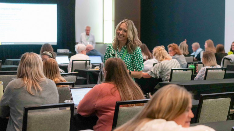 IRRC staff member chats with conference attendees during a workshop session