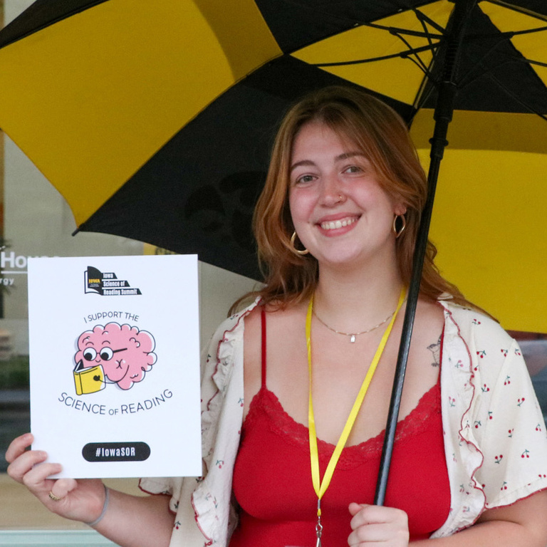 IRRC staff member holds an umbrella and a LIFTER sign.