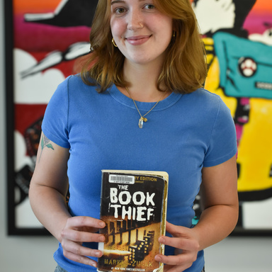 IRRC staff member holding the book The Book Thief