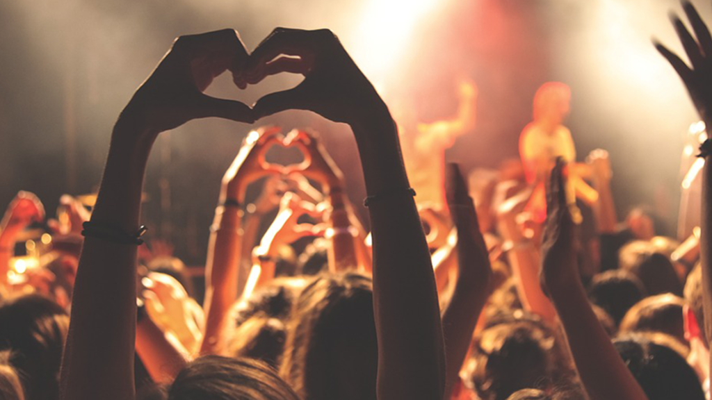 Hands up of an audience at a concert forming a heart