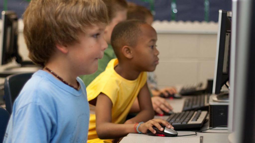 Students in a computer lab using them for book reports