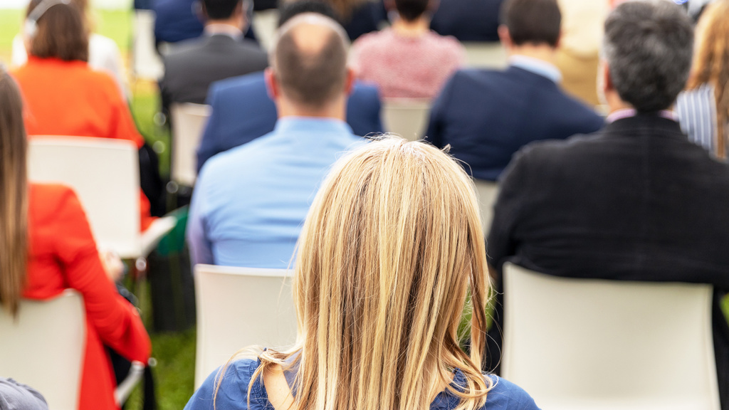 Teachers sitting in a conference room watching a presentation