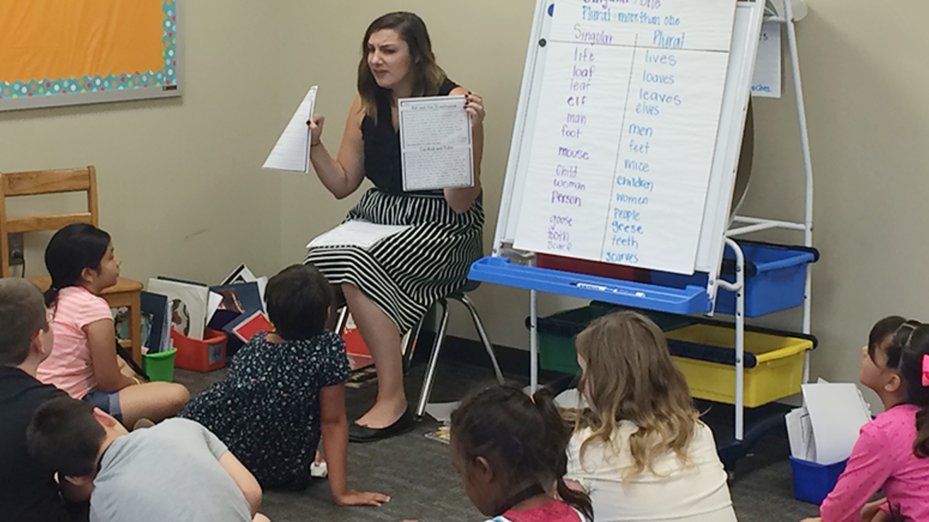 Students working with a teacher in Council Bluffs during the Intensive Summer Reading Program Study in the summer of 2016.